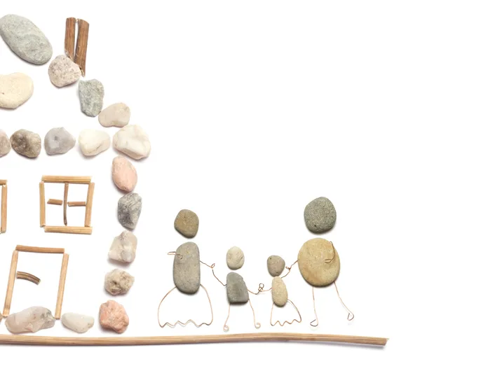 House and family figure made of natural stones